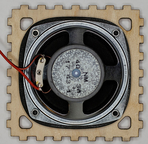 The speaker is bolted to the bottom panel